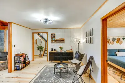 a living room with a bed and a table and chairs at Stylish Catskills Retreat Year-Round Adventure! in Round Top