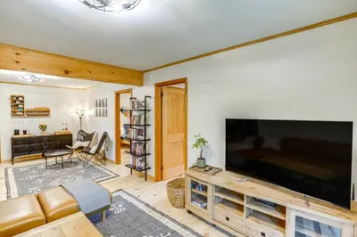 a living room with a large flat screen tv at Stylish Catskills Retreat Year-Round Adventure! in Round Top