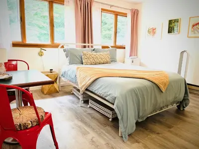 a bedroom with a bed and a table and a chair at Catskills, The Bohemian Dream in Shandaken