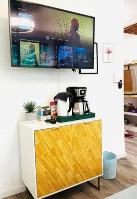 a kitchen with a tv on a wall at Catskills, The Bohemian Dream in Shandaken