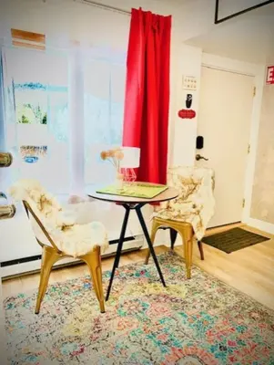 a living room with a table and two chairs at Catskill Cabin Bird of Paradise 7 in Shandaken