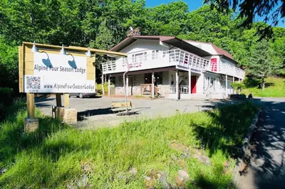a building with a sign in front of it at Catskill Cabin Bird of Paradise 7 in Shandaken