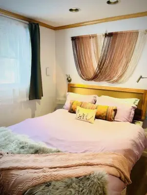 a bedroom with a large bed with a pillow on it at Catskill Cabin Bird of Paradise 7 in Shandaken