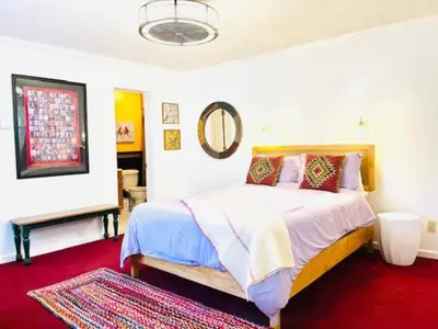 a bedroom with a bed and a red carpet at Red Peacock Catskill Cabin sleeps four 6 in Shandaken