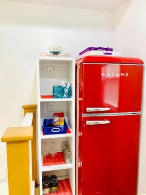 a red refrigerator in a room with a shelf at Red Peacock Catskill Cabin sleeps four 6 in Shandaken