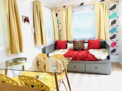 a living room with a couch and a glass table at Red Peacock Catskill Cabin sleeps four 6 in Shandaken