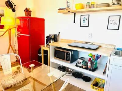 a kitchen with a table and a red refrigerator at Lotus Family Suite w 2 Beds Kitchenette 4 in Shandaken