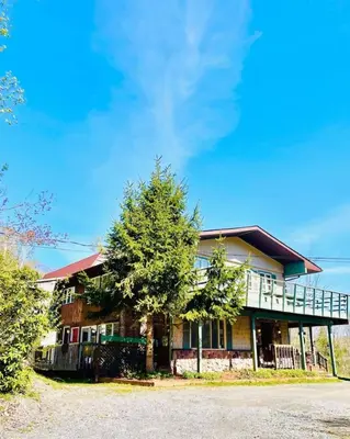 a house with a tree in front of it at Lotus Family Suite w 2 Beds Kitchenette 4 in Shandaken