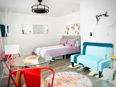 a room with a bed and a table and chairs at Catskill Cabin Hummingbird Suite 2 in Shandaken