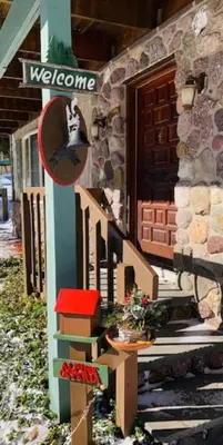 a house with a welcome sign on the side of it at Catskill Cabin Hummingbird Suite 2 in Shandaken