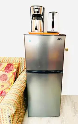 a refrigerator sitting next to a couch with a coffee maker at Catskill Cabin Hummingbird Suite 2 in Shandaken