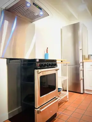a kitchen with a stove top oven in a kitchen at Catskill Cabin Duplex Apartment in Shandaken