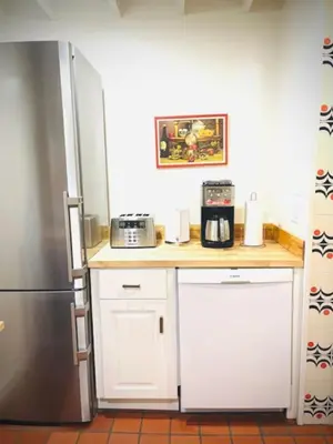 a kitchen with a counter with a microwave and a refrigerator at Catskill Cabin Duplex Apartment in Shandaken