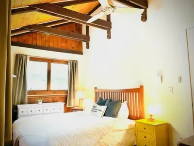 a bedroom with a large white bed and a window at Catskill Cabin Duplex Apartment in Shandaken
