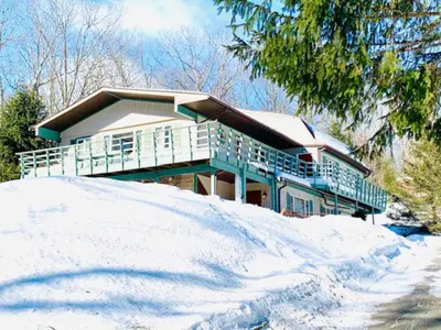 a house on top of a pile of snow at Guest Favorite Garuda Apartment 8 in Shandaken
