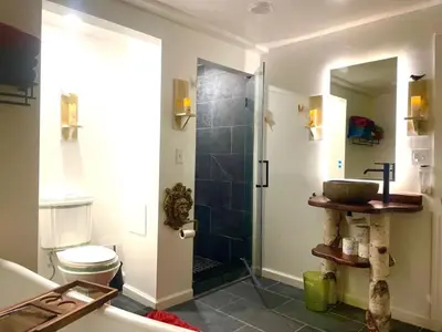 a bathroom with a shower with a toilet and a sink at Guest Favorite Garuda Apartment 8 in Shandaken