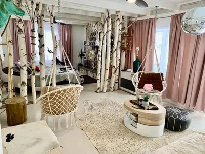 a bedroom with a bed and some trees at Guest Favorite Garuda Apartment 8 in Shandaken