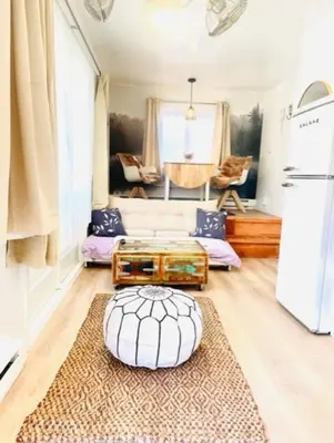a living room with a couch and a table at Catskill Cabin Little Owl Apt 1 in Shandaken