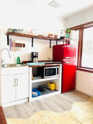 a kitchen with a red refrigerator and white cabinets at Catskill Cabin Zen Mantra Apt in Shandaken