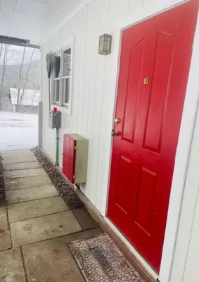 a red door on the side of a house at Catskill Cabin Apres Ski in Shandaken
