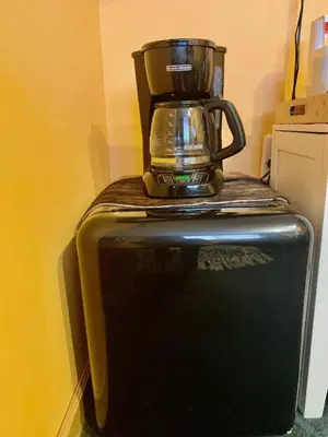 a blender sitting on top of a black refrigerator at Catskill Cabin Apres Ski in Shandaken
