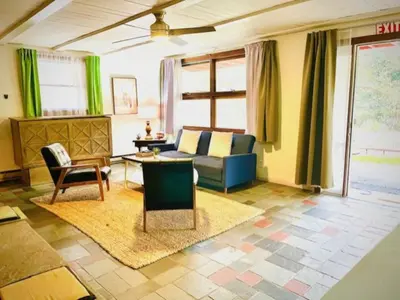 a living room with a couch and a table at Alpine Four Season Lodge Shandaken NY sleeps 18 in Shandaken