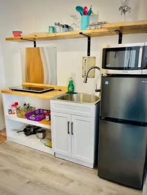 a kitchen with a sink and a stainless steel refrigerator at Alpine Four Season Lodge, Belleayre NY, Sleeps 22, in Shandaken