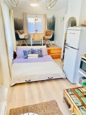 a bed in the middle of a tiny house at Alpine Four Season Lodge, Belleayre NY, Sleeps 22, in Shandaken