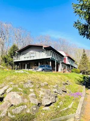 a large house with a car parked in front of it at Alpine Four Season Lodge, Belleayre NY, Sleeps 22, in Shandaken