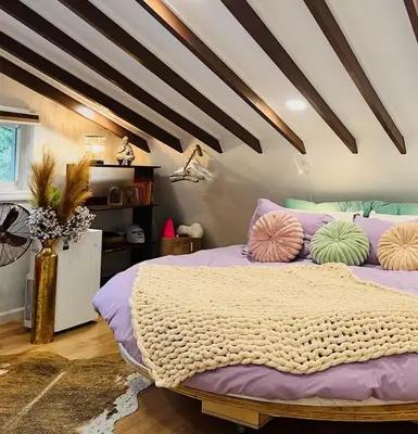 a bedroom with a bed with pillows on it at Paloma, Large Attic Apartment in Shandaken