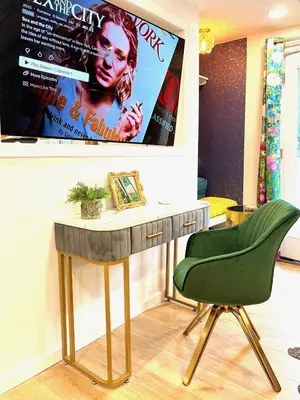 a table and a green chair in a room at Paloma, Large Attic Apartment in Shandaken