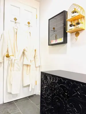 a dressing room with white coats on hangers at Paloma, Large Attic Apartment in Shandaken