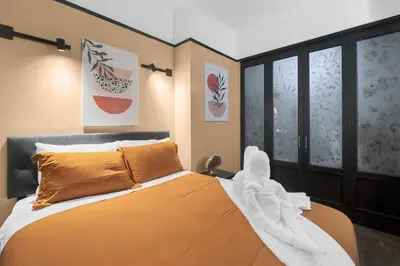 a bedroom with an orange bed with a white blanket at Stunning Condo in Heart of New York with GYM & MORE in New York
