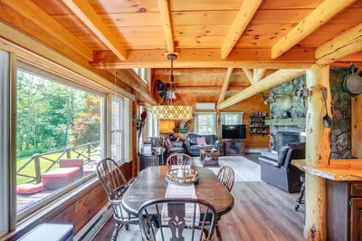 a dining room with a table and chairs in a cabin at Elegant Hudson Valley Retreat with Hot Tub and Pond in Austerlitz