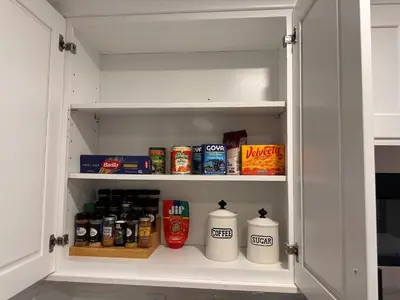 a cupboard filled with lots of food and drinks at 4 bed Luxury house in Schenectady