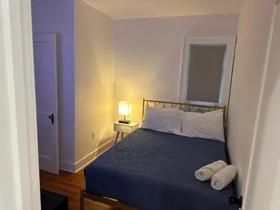 a bedroom with a bed with two towels on it at 4 bed Luxury house in Schenectady