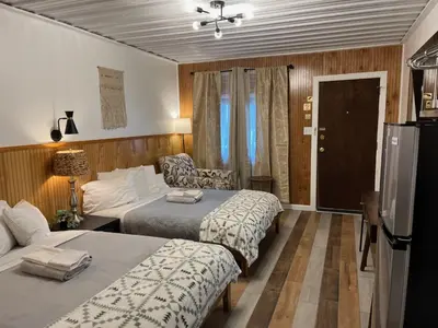 a hotel room with two beds and a couch at High Point Mountain Motel in Wantage
