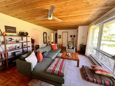 a living room with a couch and a table at The Mod Cabin in Bearsville