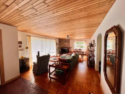 a living room with a couch and a table at The Mod Cabin in Bearsville
