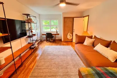 a living room with a couch and a table at The Mod Cabin in Bearsville
