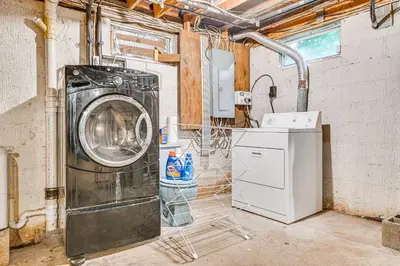 a washer and dryer in a laundry room at Pet-Friendly Home with Beach in Northville! in Northville