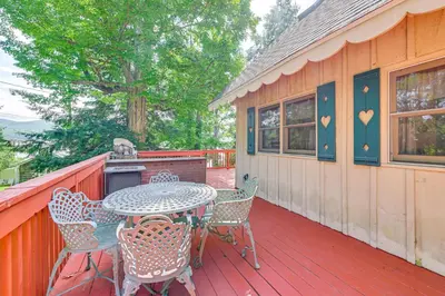 a patio with a table and chairs on a deck at Pet-Friendly Home with Beach in Northville! in Northville
