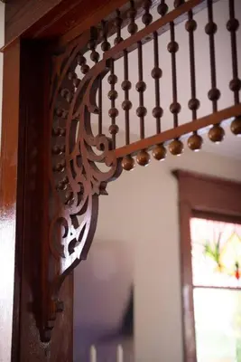 a close up of a wooden stair railing with a window at Dancing Doe Estate - Delaware Valley Escape with Wood Stove and Hot Tub in Jeffersonville