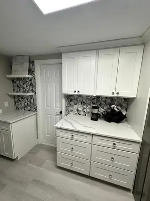 a kitchen with white cabinets and a wine cellar at Luxurious, newly renovated retreat in Springfield