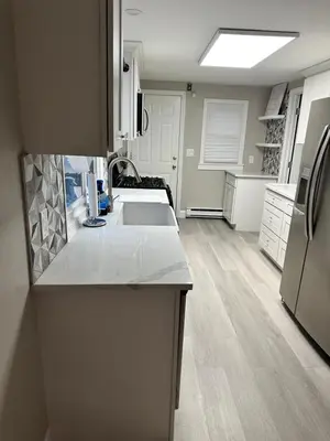 a kitchen with white counter tops and a refrigerator at Luxurious, newly renovated retreat in Springfield