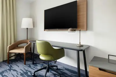 a room with a desk and a chair and a tv at Fairfield by Marriott Inn & Suites Union in Union