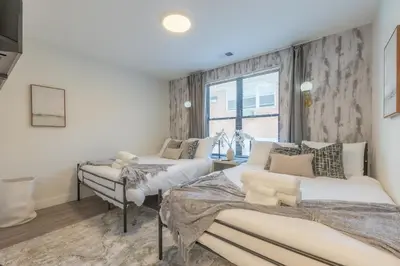 a bedroom with two beds and a window at Opulence in Olive with Free Parking plus EV Plug, 2 BR 2 baths Suite, 5 beds and Sleeps 8 in Orange