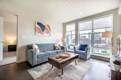 a living room with a couch and a table at New Luxury Apt Downtown with Pool in Stamford