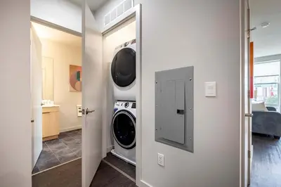 a washer and dryer in a room at New Luxury Apt Downtown with Pool in Stamford