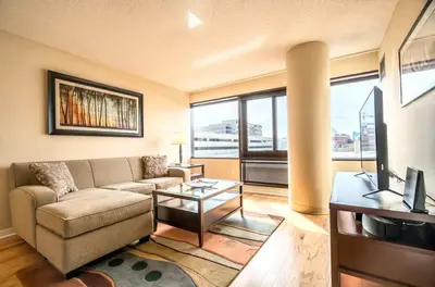 a living room with a couch and a tv at Serene Apt Downtown in Stamford